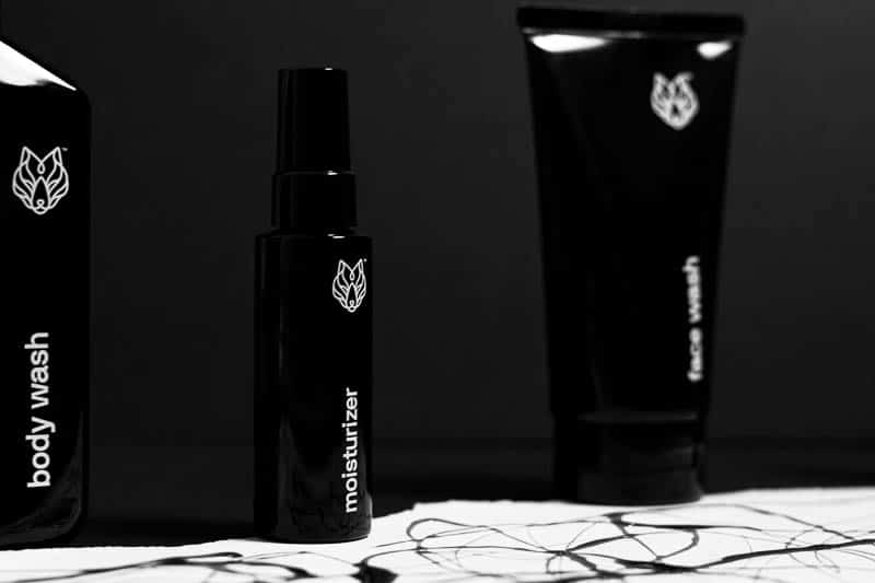 black wolf body care products against black background