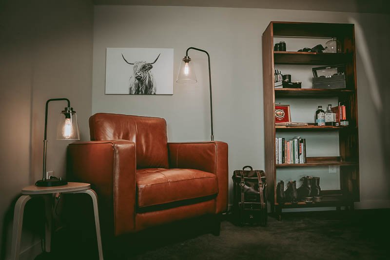 broad view of man cave with leather chair