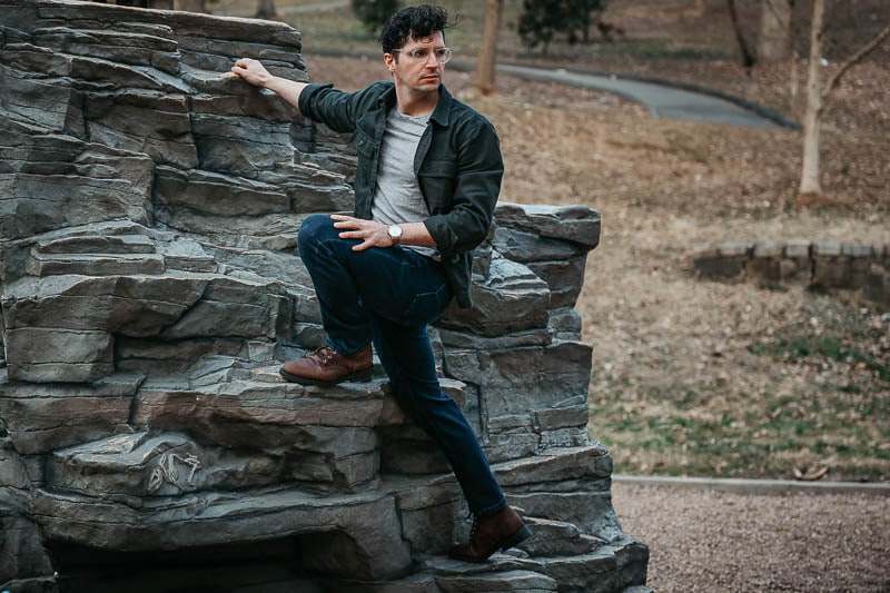 epic model standing on rock ledge in The Perfect Jean blue denim