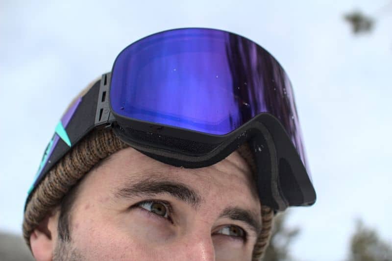 inuit goggles with purple lens on head