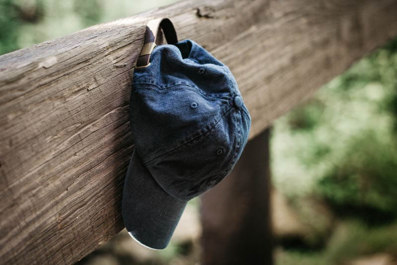 j crew baseball cap propped on wood beam