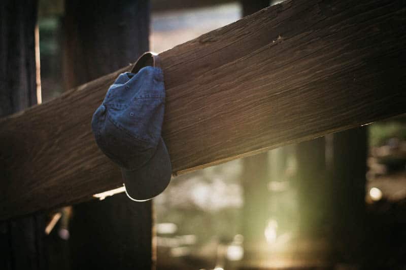 j crew hat propped on wood beam