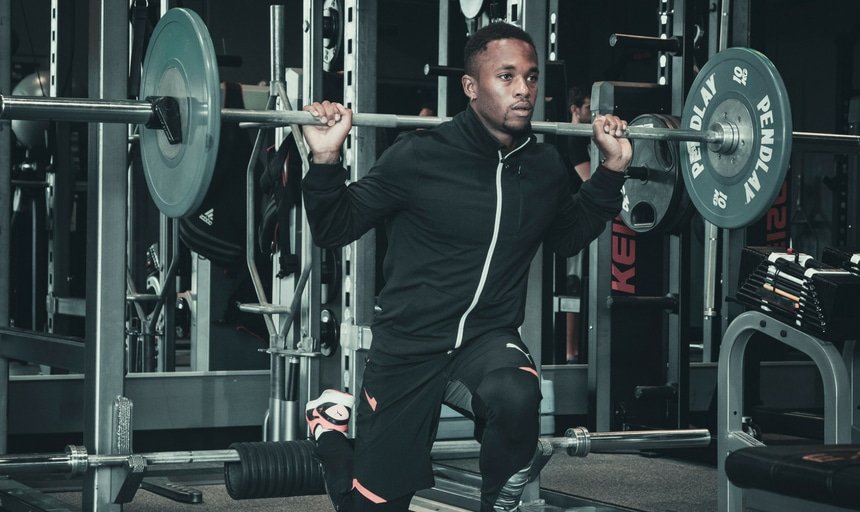 Man holding a barbell during a set