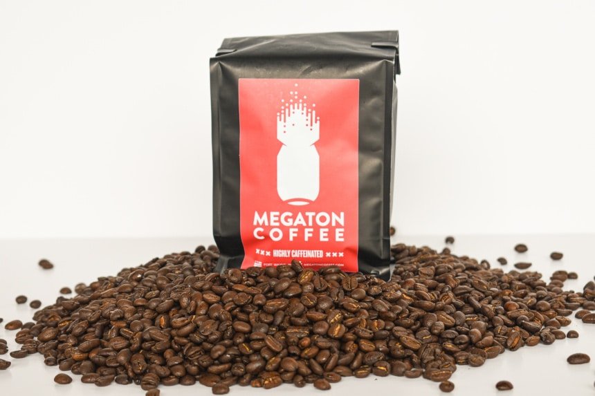 Megaton Coffee Packet Front Open with Beans in Foreground on White Background