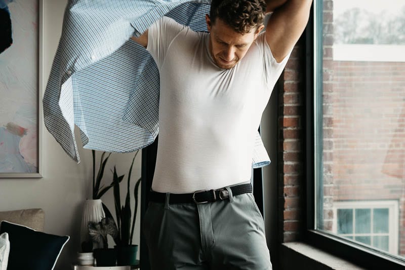 model putting on overshirt on tommy john undershirt 1