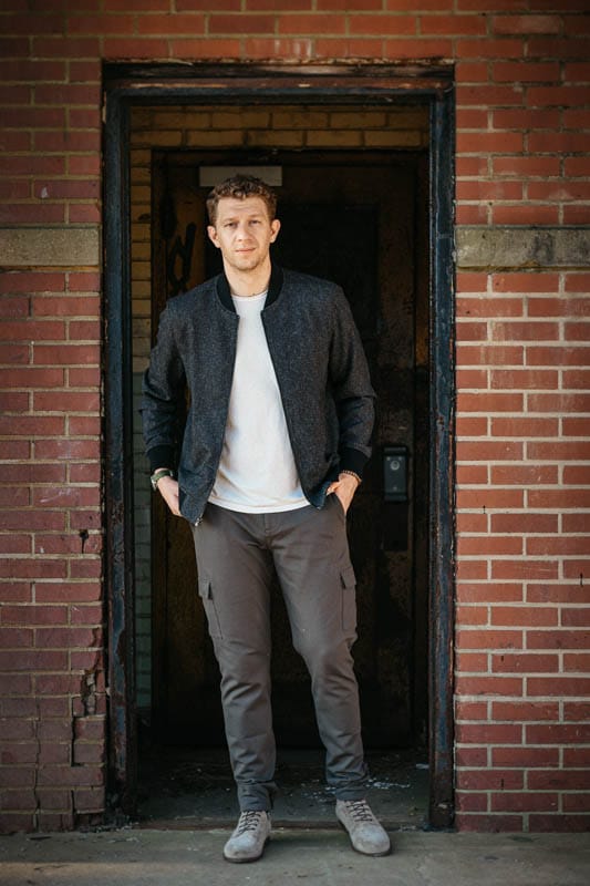 model standing in brick doorway wearing paige jacket and suede boots