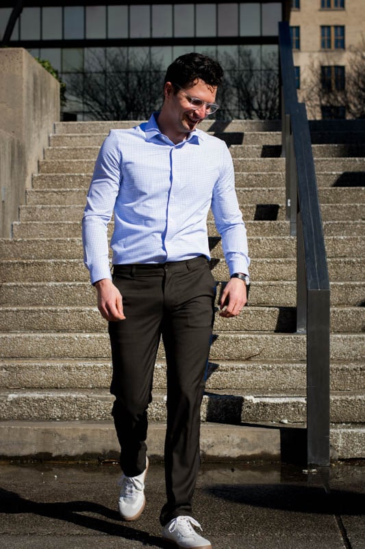 model walking down stairs wearing truwear prodigy pants and performance dress shirt