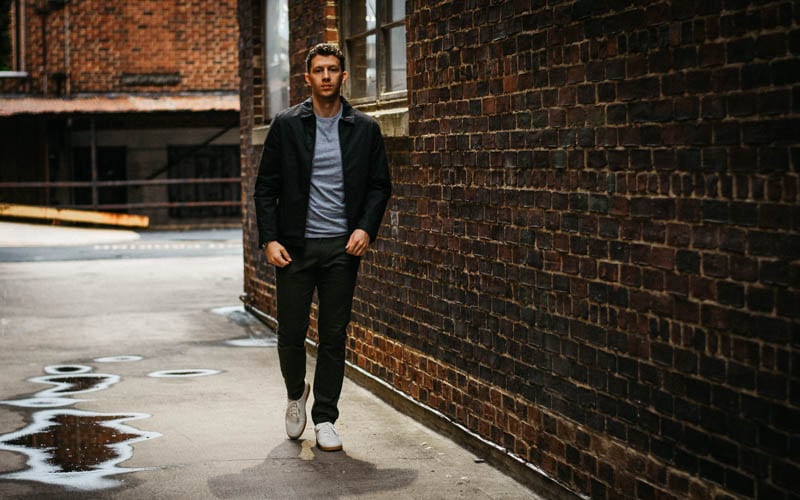 model walking in alley with asket minimalist outfit