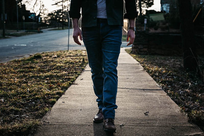 model walking in blue jeans and brown boots