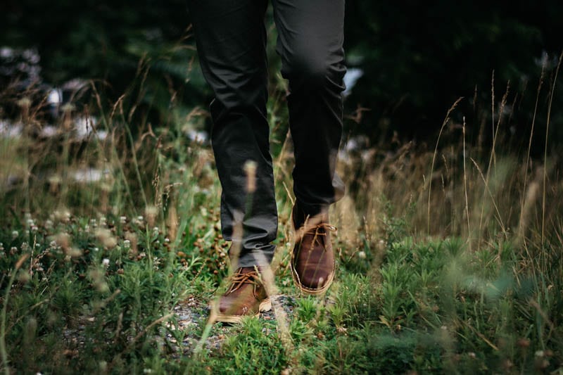 Model walking in grass with clarks desert boot