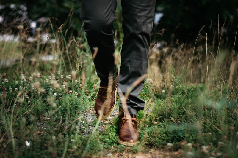 model walking toward camera wearing clarks desert boot