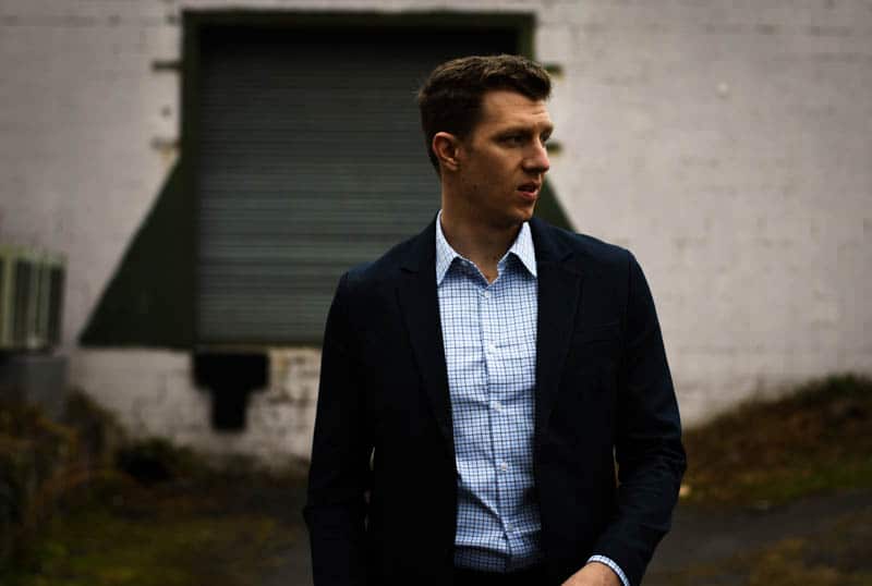 model walking toward photographer navy suit blue checked dress shirt