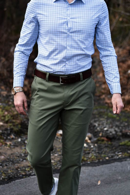 model walking wearing wooden watch green chino and blue checked dress shirt