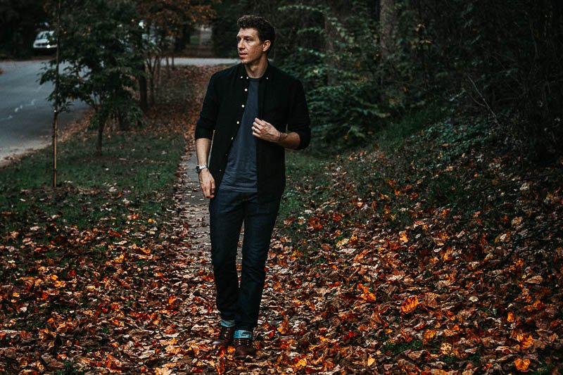 model wearing black unbuttoned Frank And Oak oxford shirt