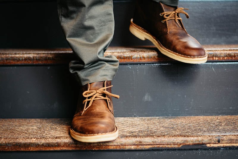 Model Wearing Clarks desert boot walking down stairs