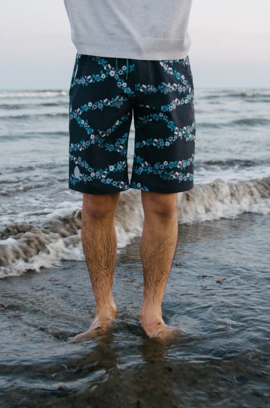 Model Wearing Stio CFS Board Short Close Up on Legs In The Water At The Beach