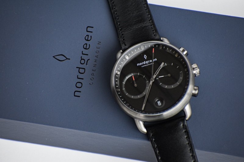 nordgreen pioneer black dial against blue packaging