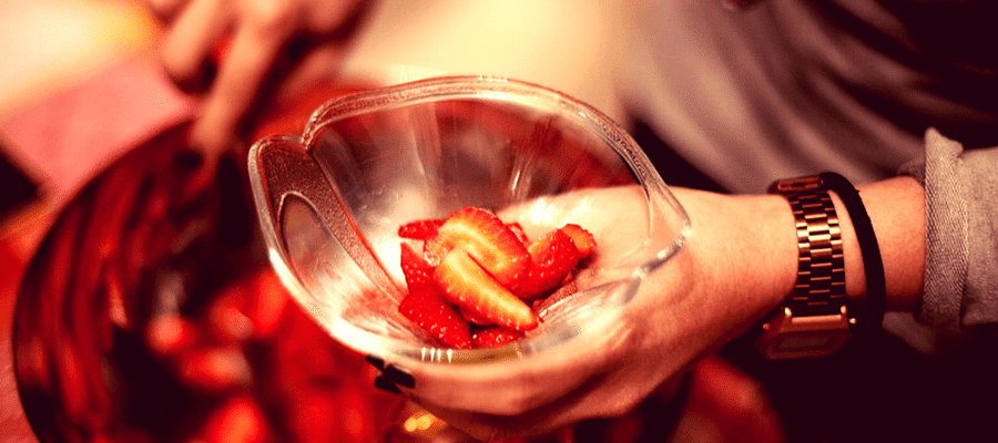 Man holding bowl of strawberries