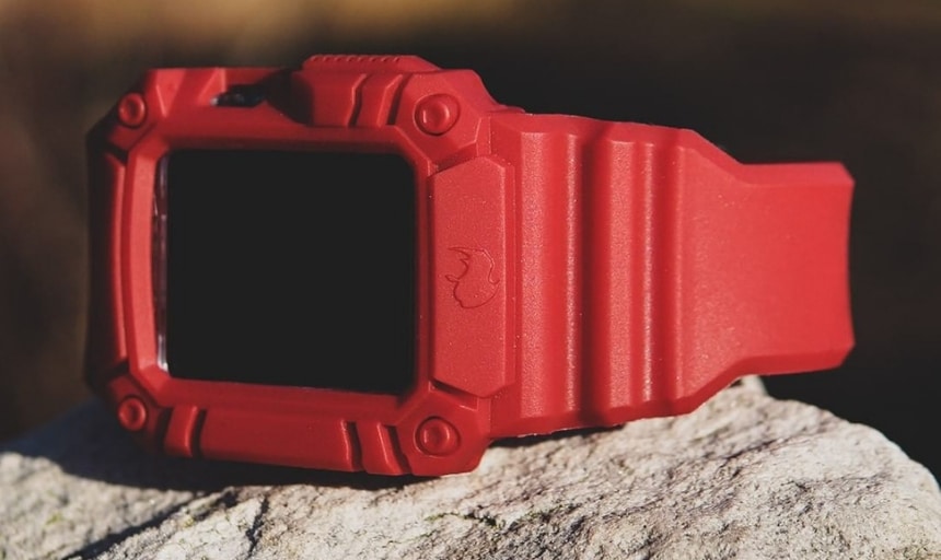 Rhino Band Runner Red on side with grooves showing and sitting on a rock outdoors