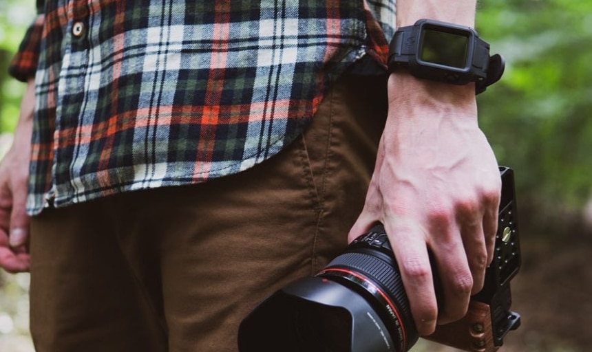 Rhino Band Stealth black on wrist while holding a camera