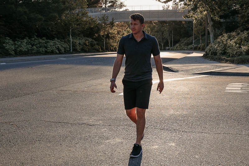 TravisMathew model walking with shorts