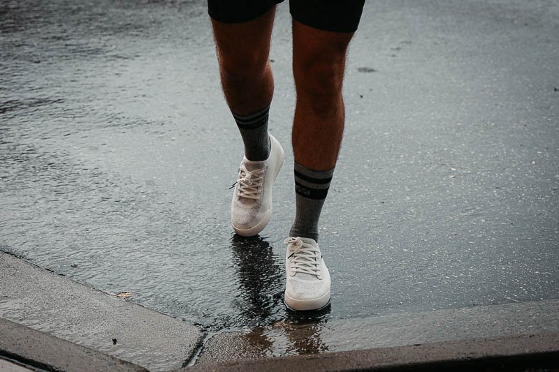 vessi white sneakers in a puddle